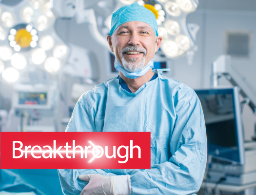 A healthcare professional in scrubs standing inside an operating room, ready to provide medical care.