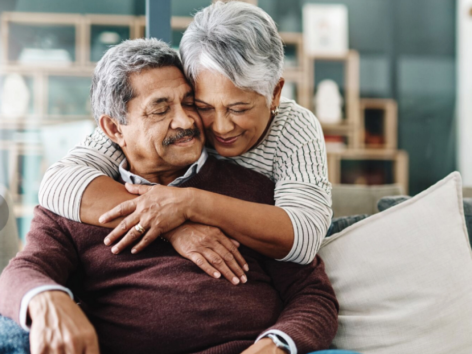 Two long-term care residents enjoying a hug